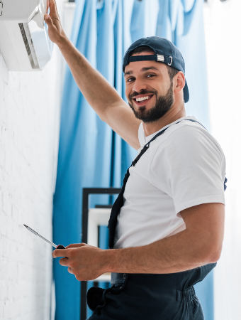 smiling-workman-looking-at-camera-while-repairing-2021-09-21-23-34-35-utc-1-1.jpg